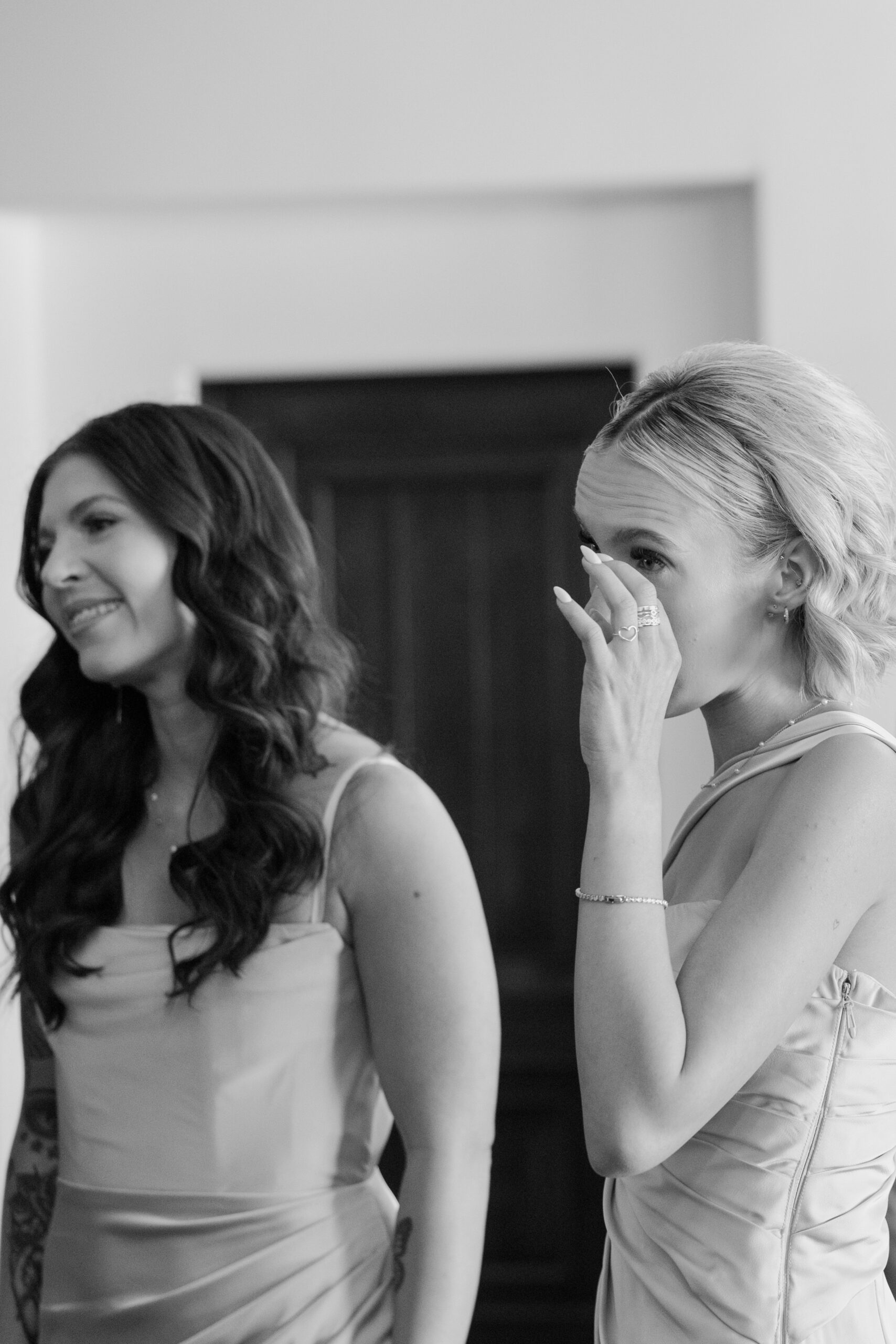 Bridesmaid wiping a happy tear while watching the bride get ready at the Omni Montelucia.