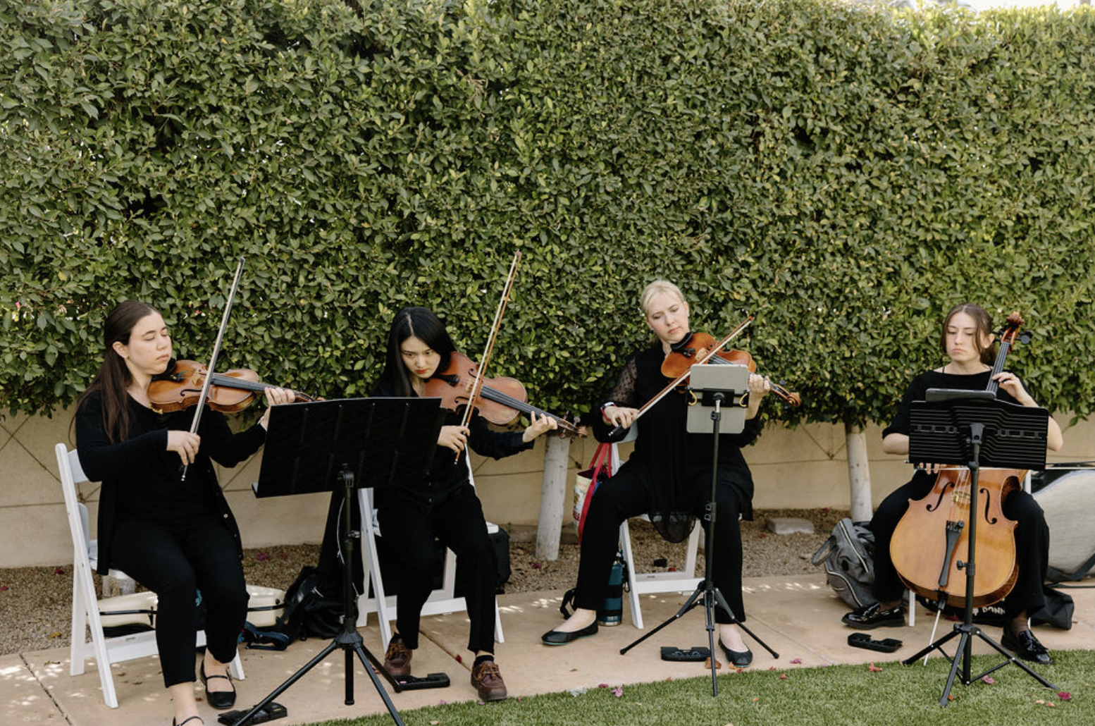 A live string quartet performs outdoors at the Omni Montelucia during the wedding ceremony.