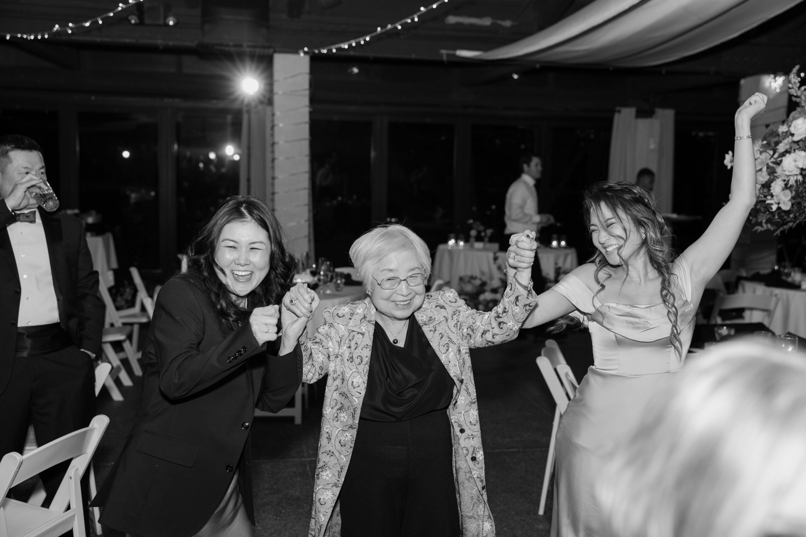 Three generations holding hands and celebrating together during the reception at McCormick Ranch Golf Club.