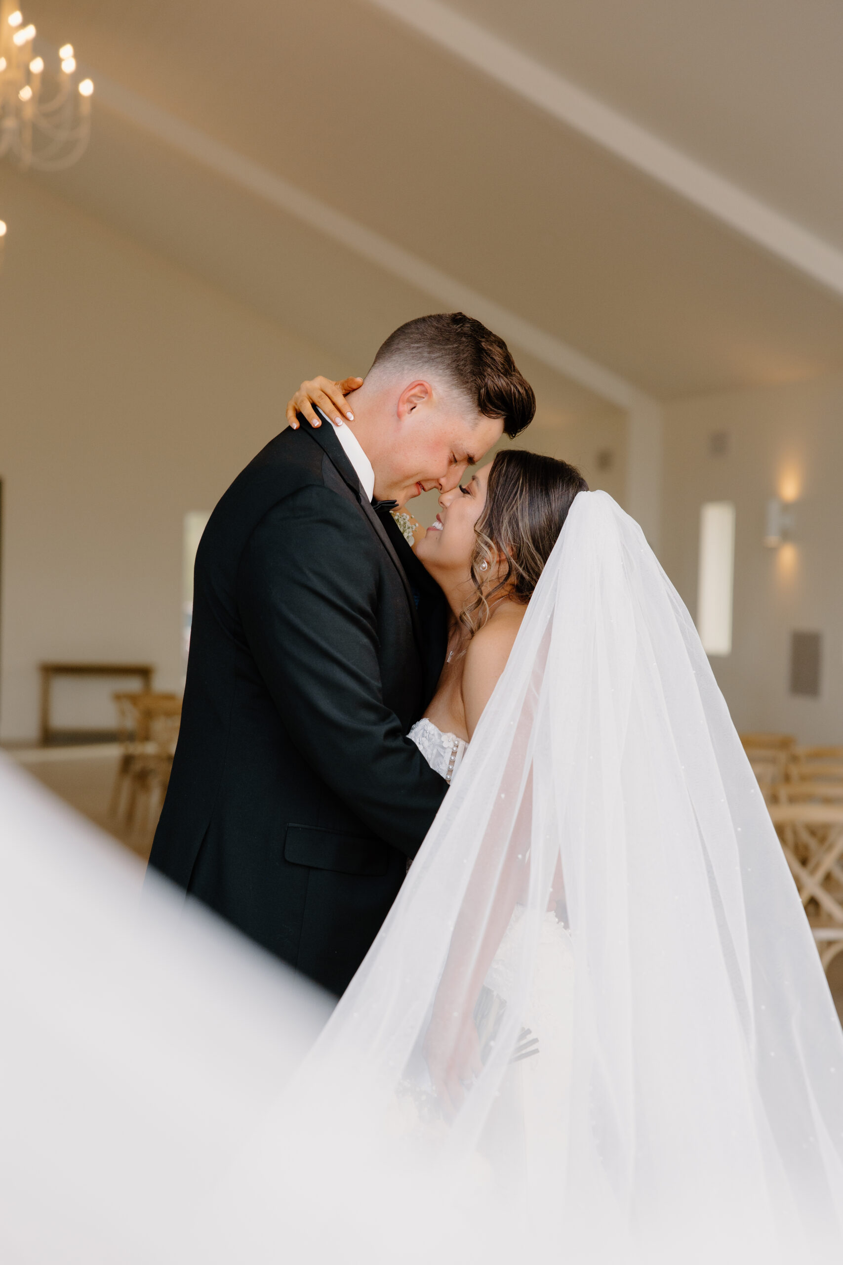 Bride and groom embracing during an intimate moment inside the chapel after their Desert View wedding ceremony.