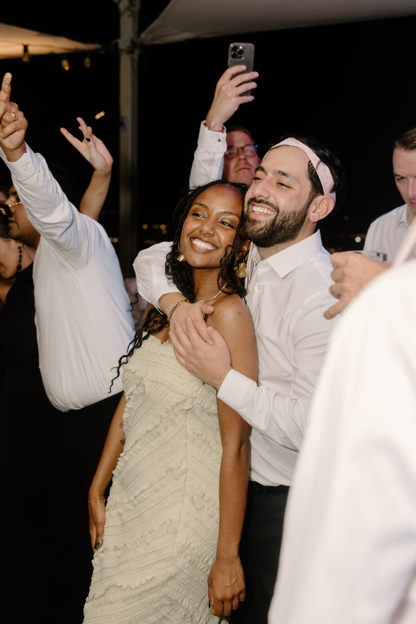 Guests dancing and taking selfies on the dance floor during a high-energy wedding reception at Hotel Valley Ho