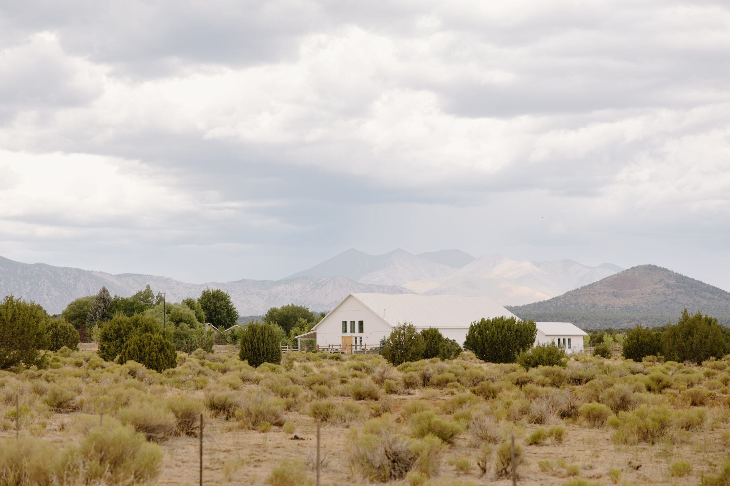 Wide landscape view of The Sycamore, Flagstaff wedding venue with desert scenery and mountain backdrop