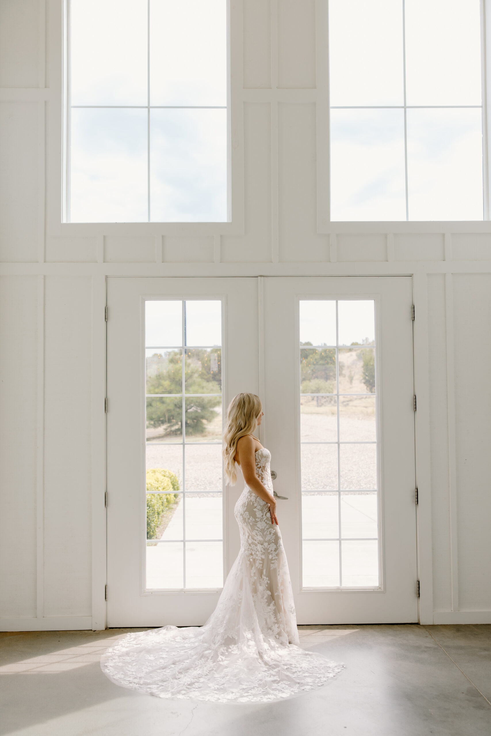 Bridal portrait inside the venue with natural light streaming through tall windows at The Sycamore, Flagstaff