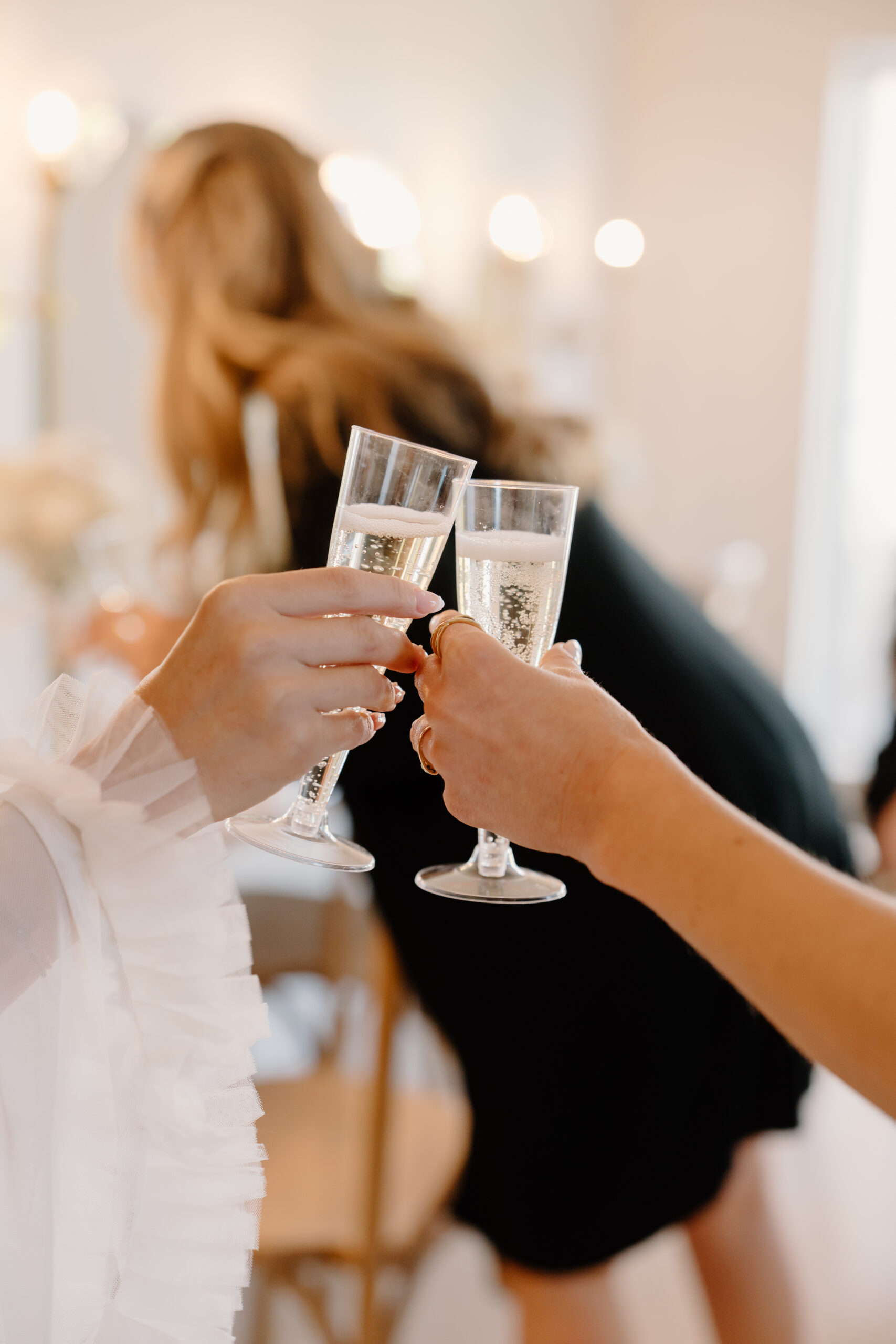 Arizona wedding photographer capturing a celebratory champagne toast while the bride gets ready for her wedding day.
