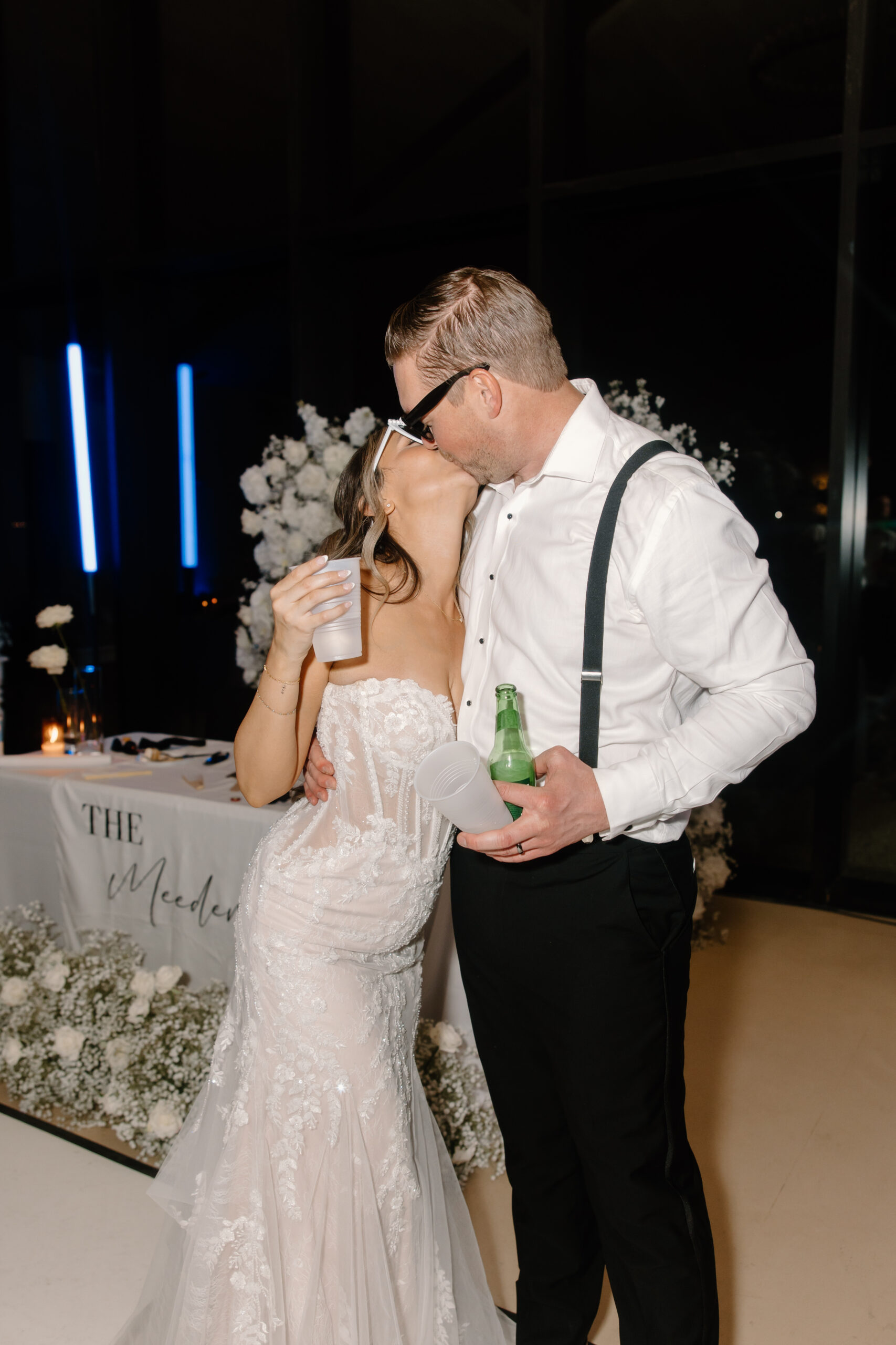 Bride and groom kissing on the dance floor during their reception, a fun flash photography moment from an Arizona wedding photographer.